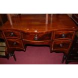 A 19th century mahogany serpentine front kneehole sideboard, having an arrangement of four drawers