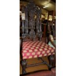 A late 19th century Caroleon style relief carved oak high backed single dining chair, having red