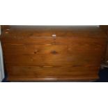 A Swedish stained pine domed and hinge topped blanket box, having iron end carry handles, w.107cm