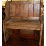 A rustic stained pine two seater panel back pew, width 80cm