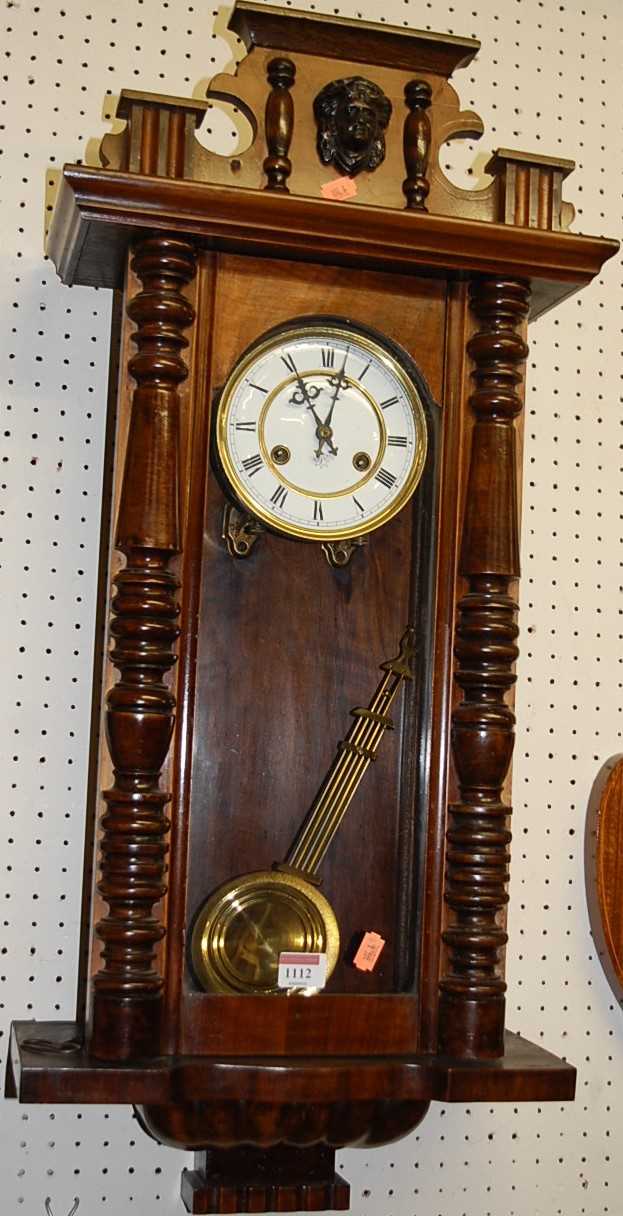 An early 20th century figured walnut Vienna drop trunk wall clock