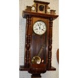 An early 20th century figured walnut Vienna drop trunk wall clock