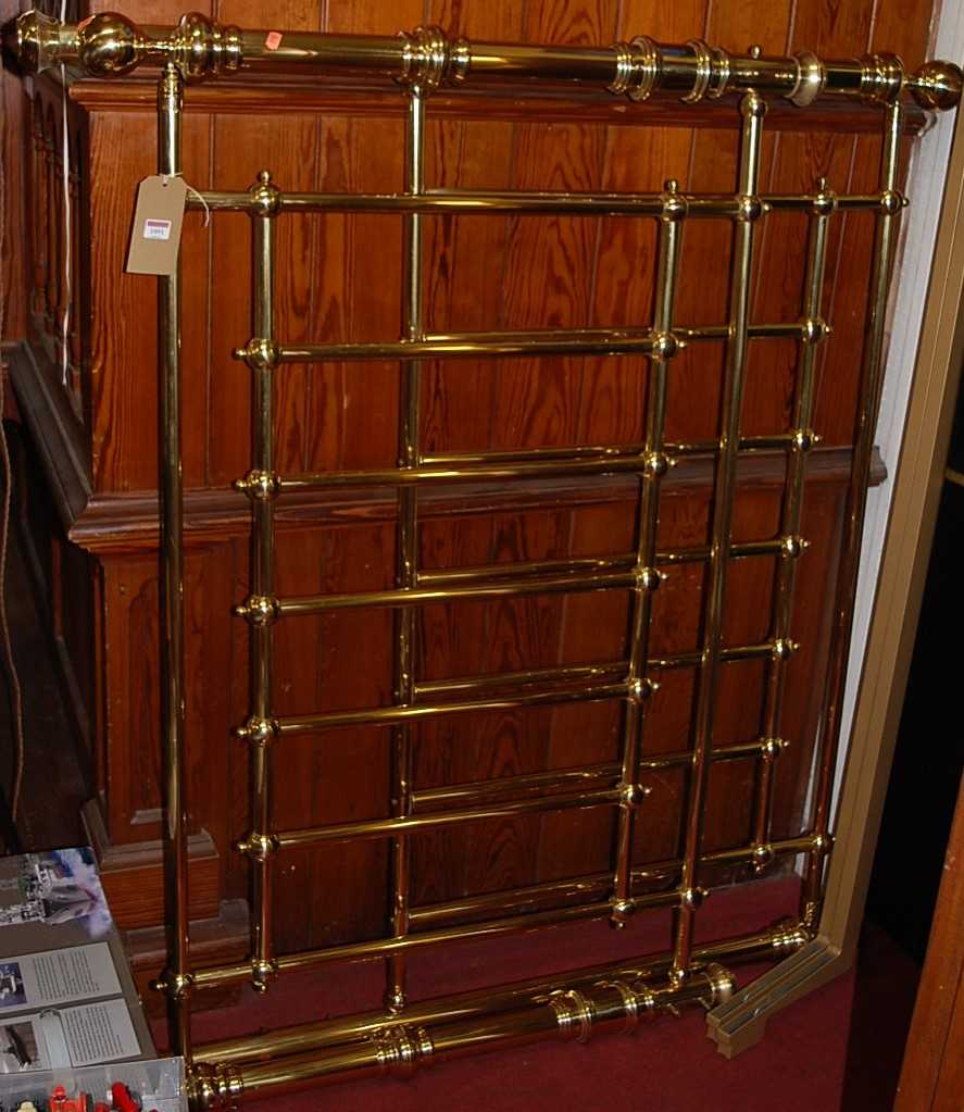 A contemporary polished tubular brass double bedstead, having side rails