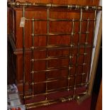 A contemporary polished tubular brass double bedstead, having side rails