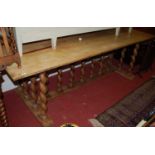 An early 20th century Continental faded walnut and pine plank topped refectory table, raised on