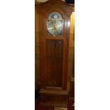 A contemporary oak long case clock, having glazed trunk door with silvered and brass arched