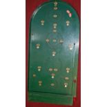 A 1950s Chad Valley green painted bagatelle board, with replacement marbles