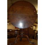 A 19th century provincial oak circular tilt-top pedestal tripod table, dia. 77.5cm