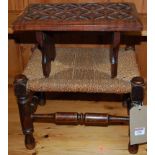 An early 20th century walnut relief carved foot stool, together with a further rush top foot