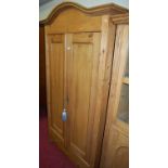 A French pine double door armoire, having single long lower drawer on bun supports (comprised of two