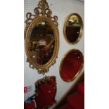 A collection of five various gilt framed decorated wall mirrors, the largest 92 x 42cm