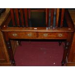 A Victorian mahogany and rexine inset round corner two drawer writing table, on turned tapering