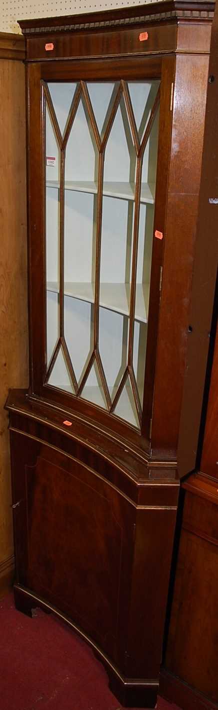 A reproduction mahogany concave freestanding corner cupboard, having glazed upper door, height