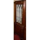 A reproduction mahogany concave freestanding corner cupboard, having glazed upper door, height