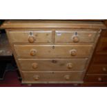 A pine chest of two short over three long graduated drawers, with turned knob handles, on turned