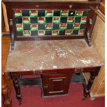 A late Victorian stained walnut and variegated marble topped tiled back washstand, w.92cm