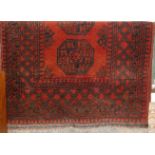 A Persian woollen red ground Bokhara rug, 160 x 110cm