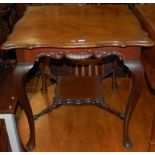 An Edwardian walnut shaped top two-tier centre table, raised on hipped cabriole supports, width