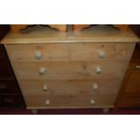 A Victorian pine round cornered chest of two short over three long graduated drawers, on turned