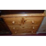 A modern pine squarefront chest, of two short over two long drawers with turned knob handles, w.