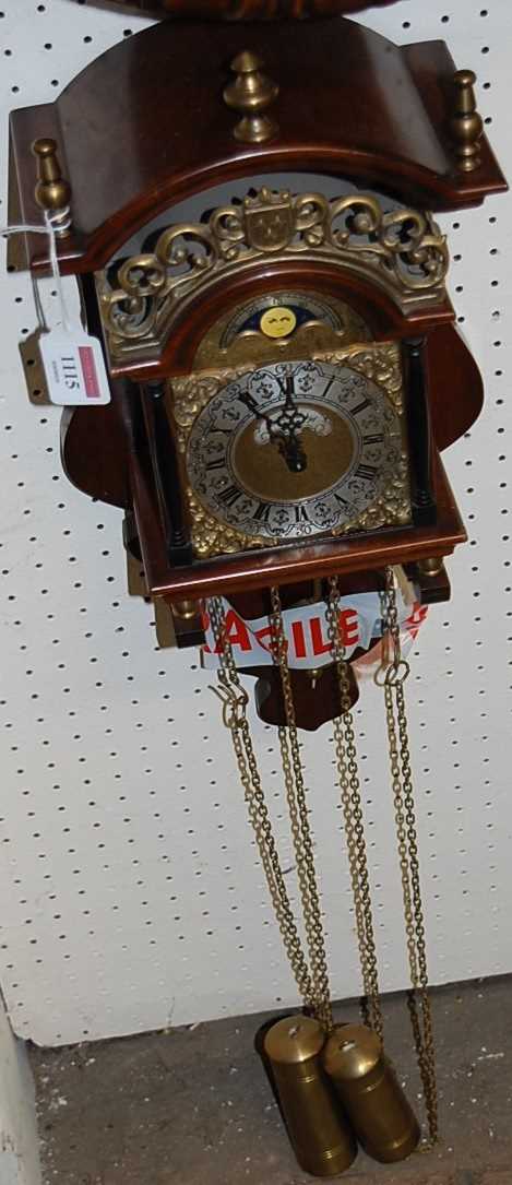 A reproduction Dutch Sallander Warmink wall clock, having twin weight driven movement with pendulum