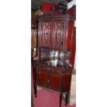 A circa 1900 mahogany Chippendale Revival freestanding corner cupboard, having a raised pediment