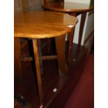 A mahogany circular occasional table; together with an oak shaped top occasional table (2)