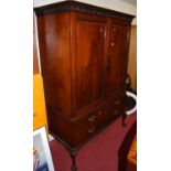 A circa 1900 Chippendale style mahogany cupboard on stand, the twin recessed panelled upper doors