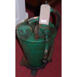 A green painted cast metal standing oil pump