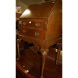 A 1930s figured walnut slopefront two drawer lady's writing bureau, w.61cm