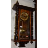 An early 20th century walnut Vienna droptrunk wall clock