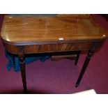A 19th century mahogany round cornered fold-over card table, raised on reeded slightly tapering