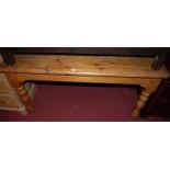 A modern pine round cornered farmhouse kitchen table, raised on turned supports, length 136cm