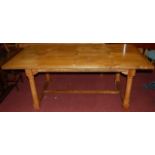 A contemporary hardwood and inlaid refectory table, raised on turned and square cut supports, united