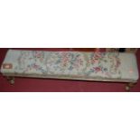 A 19th century floral gilt decorated and tapestry upholstered long foot stool, length 115cm