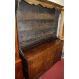 An 18th century and later oak dresser, the three tier plate rack over base fitted with three