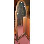 An early 20th century walnut framed shaped arch topped cheval mirror