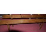 A pair of rustic oak long trestle benches, each raised on 'A' frame end supports, length 199cm