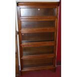 A 1930s oak five-tier stacking bookcase, of graduated form, each section with typical hinged