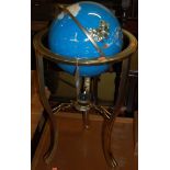 A contemporary polished brass framed and hardstone inset revolving globe on stand