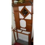 An Edwardian reeded and panelled oak mirrorback hallstand, with brass scarf rail and twin division