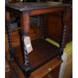 A 1930s oak square section two-tier occasional table, having barley twist turned supports, width