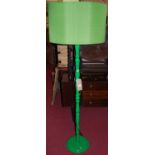 A contemporary green painted turned standard lamp, with matching colour shade