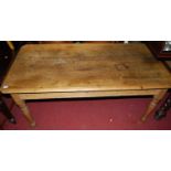 A Victorian pine farmhouse kitchen table, having single end drawer and raised on turned tapering