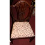 A set of seven 19th century mahogany Heppelwhite style dining chairs, each having re-upholstered