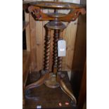 A mid-Victorian walnut spiral turned wash-bowl stand, of circular form, with relief carved floral