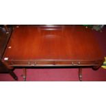 A reproduction mahogany dropflap sofa table, having twin frieze drawers, w.104cm (leaves down)