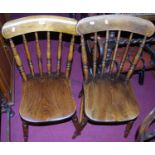 A pair of early 20th century elm and beech stick back kitchen chairs