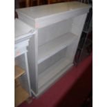 A circa 1900 and later grey painted low free standing open bookshelf, having adjustable shelves,