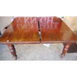 A late Victorian mahogany extending dining table, having wind-out action and two extra drop-in